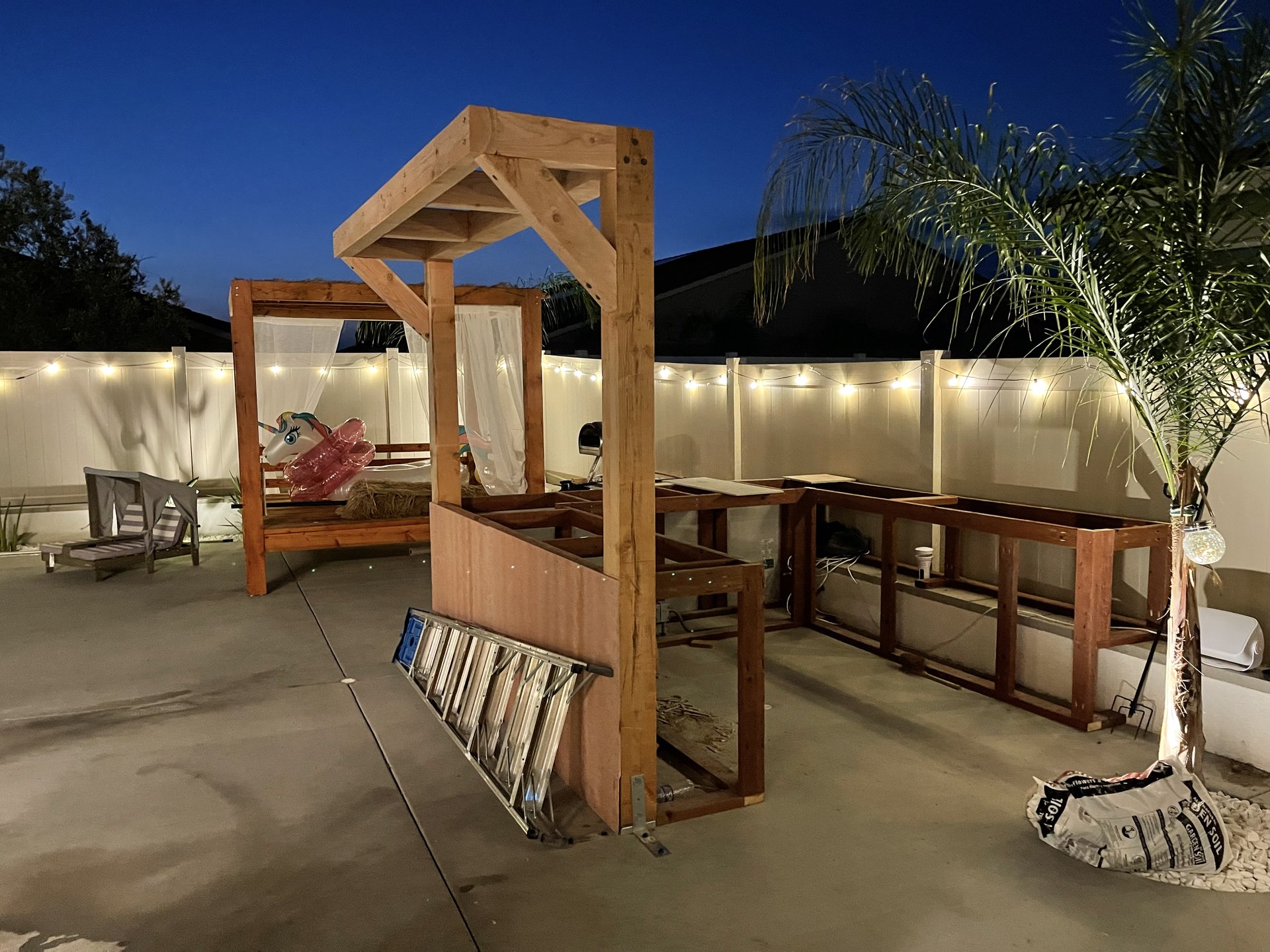 Pergola structure under construction at blue hour