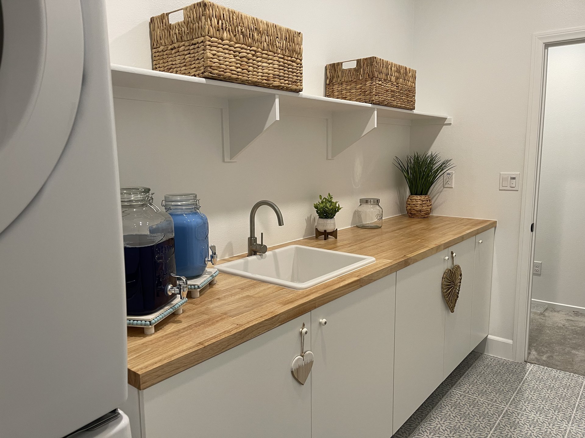 Butcher block counter with utility sink and open shelving — Menifee