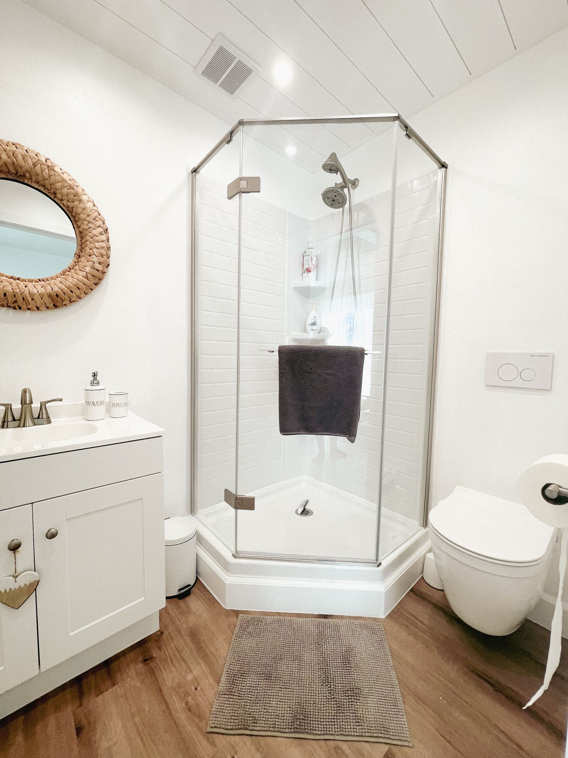 Finished bathroom with neo-angle shower and shiplap ceiling — Menifee